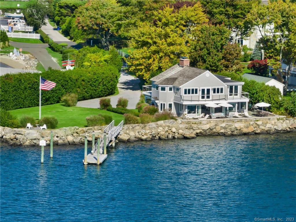 Unrivaled Retreat by the Sea with a 230' water frontage and a deep water dock. Just imagine if you woke up to the sea breeze, sounds and salty water views from every room in the house. This open concept, well designed casual coastal home boasts patios and decks, a well manicured lawn and garden in a private setting on Wilson Point, an enclave of Rowayton. With upgrades throughout, this 4 bedroom/4 bath lifestyle residence has access to a private beach, tennis, social activities and The Norwalk Yacht Club membership. Close to the restaurants and shopping in Rowayton and South Norwalk. A one hour commute to NYC.