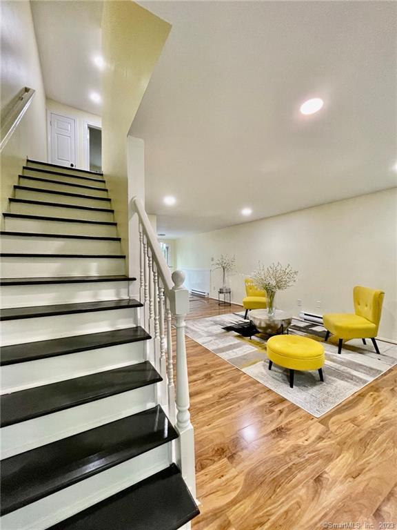 This lovely pet-friendly three-level townhome in a quiet 8-unit complex. 1st Fl: Grarge, Storage room, Laundry room. 2nd Fl: Half bath, Livingroom, Kitchen, Dining room, Balcony 3rd Fl: Bedrooms, Full Bath, Hallway, Linen closet. New Hardwood floors and recessed lighting. The kitchen has hardwood floors, granite countertops, and brand-new stainless-steel appliances, including a refrigerator, dishwasher stove, and contemporary range hood vent with sleek modern lines. Pellet stove in the living room to keep the unit warm and cozy and help to offset electric heating costs. Large bedrooms with ample closet space. Garage underneath with storage and laundry area with washer and dryer hookup. Enjoy summer evenings relaxing on your own private deck. Excellent commuter location with accessibility to major routes and highways. It is situated close to shopping, dining, entertainment, parks, and outdoor recreation.