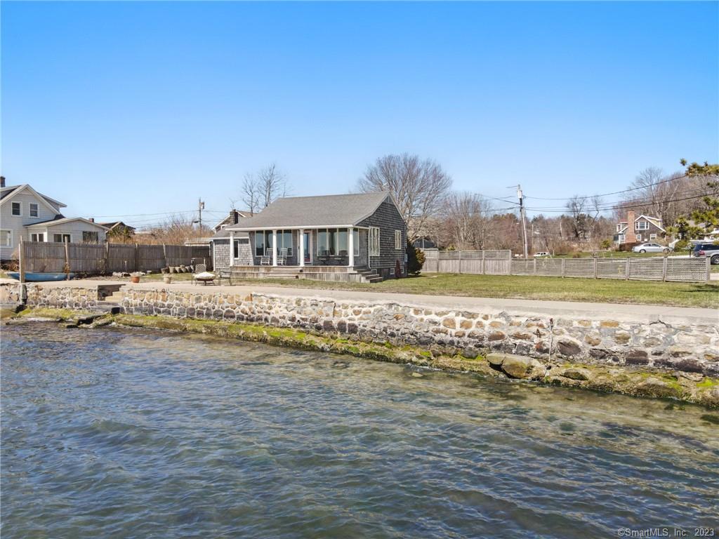 Breathtaking 115 ft Direct Waterfront Property with unobstructed views of Fisher's Island Sound! Home features an open floor plan, 2 bedrooms, 1 bath, covered deck with amazing views of the L.I Sound, renovated 1992, double lot, 1 car garage and restored seawall. Seller obtained a variance to construct a second story and Buyer is responsible for pulling all municipal permits.