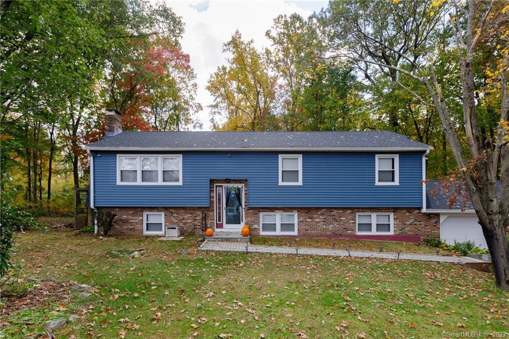 WOW! Newly remodeled 5 bedroom raised ranch with a full in-law set up. Beautiful exposed beam ceiling brings that farmhouse feel to this beautiful home. The large living room opens up to the dining room right off of the kitchen. The wood fire place is perfect for cozy winter nights by the fire. There are 2 1/2 baths throughout the home making it ideal for larger families. The master bedroom has a half bath attached. This home is perfect for families with young children as there is an additional 1294 square feet of living space on the lower level with that beautiful exposed beam ceiling. This is perfect for a playroom or a man cave! The full in law apartment is also newly renovated including a kitchen with stove, microwave and refrigerator. Plenty of cabinet space makes it functional. Brand new full bath as well. The outside of this home is surround by beautiful trees and large yard space. There is a shed located on the backside of the home and a renovated deck to enjoy cookouts in the summer! A two car garage is also attached. In addition to the indoor renovations, there has been a new roof installed as well as a brand new boiler. This home is move in ready and will not last. Schedule your showing today!