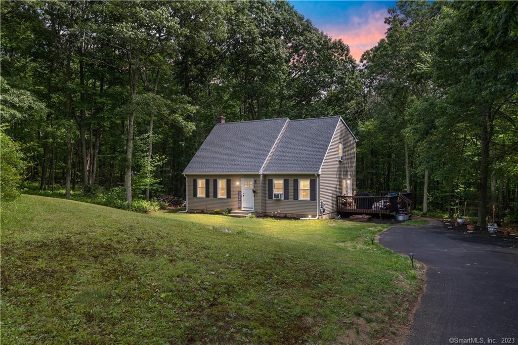 Welcome to 32 Mountain Laurel, a charming Cape-style home in Chaplin, situated on 2.01 acres, offering a cozy retreat encapsulated by nature. Tucked away as the last house on a quiet cul de sac, this private oasis provides a peaceful and tranquil living experience. With brand new vinyl windows throughout the entire house and basement, and a brand new 50-year warranty roof, including labor and materials, you can rest easy knowing that your home is protected for years to come. Adding to the appeal, a freshly paved asphalt driveway welcomes you home for low maintenance seasons ahead. Step inside to discover a fully renovated interior, thoughtfully designed with high end products. From the stylish flooring throughout to the upgraded kitchen and bathrooms, every detail has been carefully crafted to create a warm and inviting atmosphere. With four bedrooms and two full bathrooms—one on each floor—this home offers flexibility and comfort for any new home owner. Outside, a charming deck invites you to unwind and bask in the serenity of your surroundings. The clean and dry basement provides ample storage space or can be transformed into a versatile area to suit your needs. Escape to the peaceful ambiance of this remarkable property, where privacy meets comfort. Don't miss the chance to make 32 Mountain Laurel your cozy sanctuary. Schedule a showing and experience the warm embrace of this delightful home.