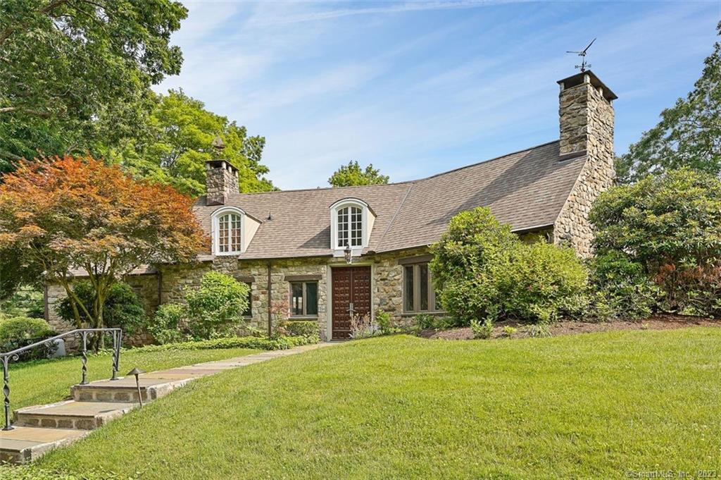 This historically and architecturally significant stone home was designed by Frazier Peters, a noted architect of fine homes and estate residences. This important example of his celebrated work is a rare opportunity to acquire a home offering tremendous character but in wonderful, turn-key condition which is ready for immediate enjoyment. The residence benefitted from a recent renovation which improved upon every aspect of the home, and the addition of a new powder room bath, refinished hardwood floors, fresh paint and other enhancements have made it better-than-ever. Set on scenic acreage in coveted Old Hill, this convenient yet private property is introduced by a gracious driveway that leads to both the impressive main house as well as a guest/rental cottage that offers tremendous flexibility. The 17th Century front doors from a European castle open into a foyer where the distinctive interiors begin to unfold, striking a balance between modern sophistication and the original charm. The two-story great room with stone fireplace, beams, a second seating area, adjacent sun room and the beautiful dining room all have views overlooking park-like areas of the property. The gourmet kitchen dazzles w/Kashmir White granite, custom cabinets, Thermador stainless steel appliances, island with seating for four, lrg pantry and amazing bkfst rm w/exposed stonework. The primary suite has dual clsts, an ultra-luxe bth w/two tons of Carrara marble, htd flr. Generator. 2 room guest cottage.